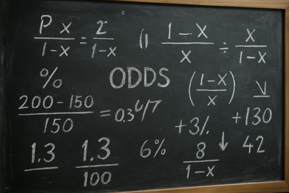 Chalkboard showing sports odds calculations