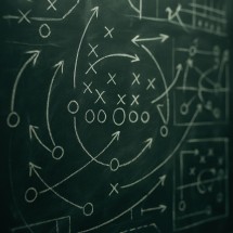 Chalkboard covered in sports statistics and game plans