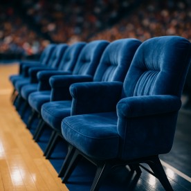 Plush velvet chairs lined up courtside for a major sporting event